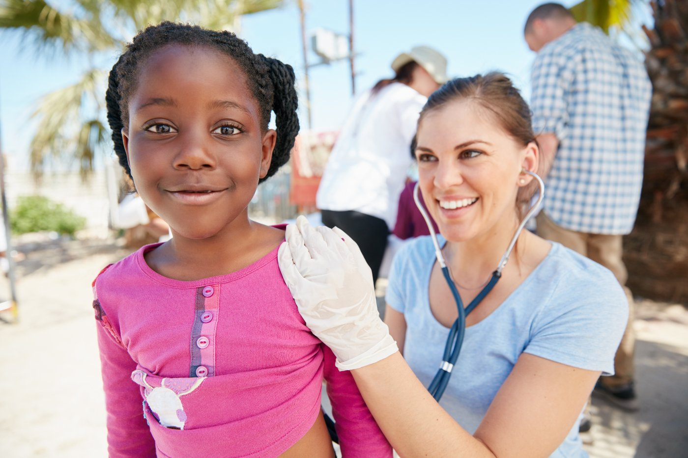 Physician engaging with a child at a community outreach event