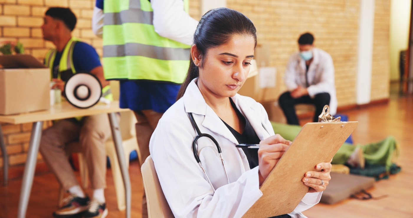 Physician reviewing notes at a community health screening event