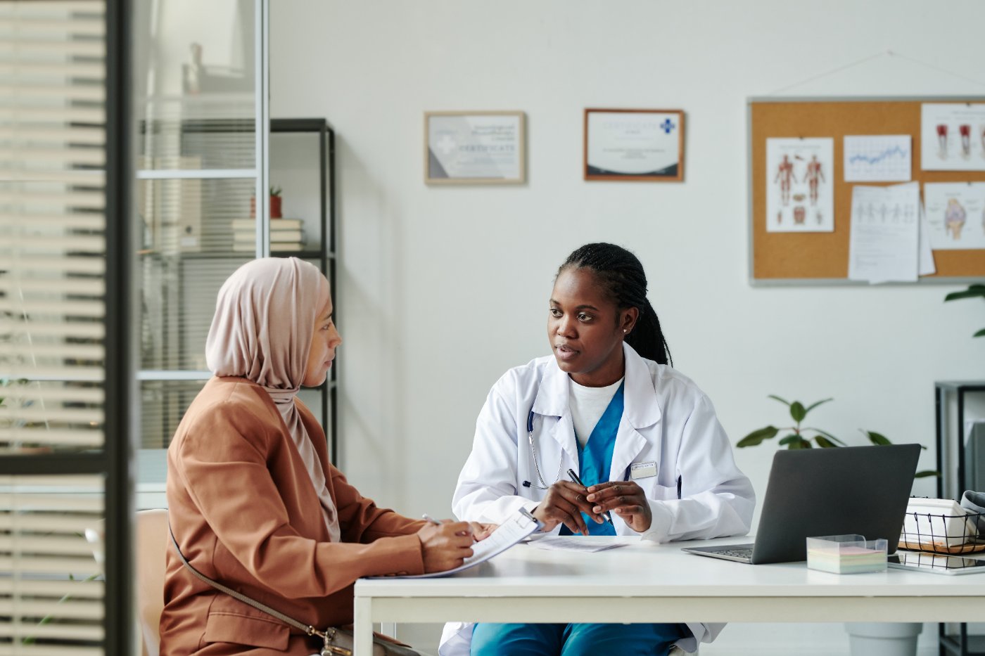 Physician consulting with a patient wearing a hijab