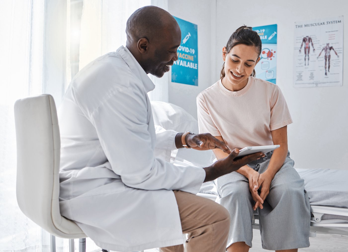 Physician reviewing a tablet with a patient