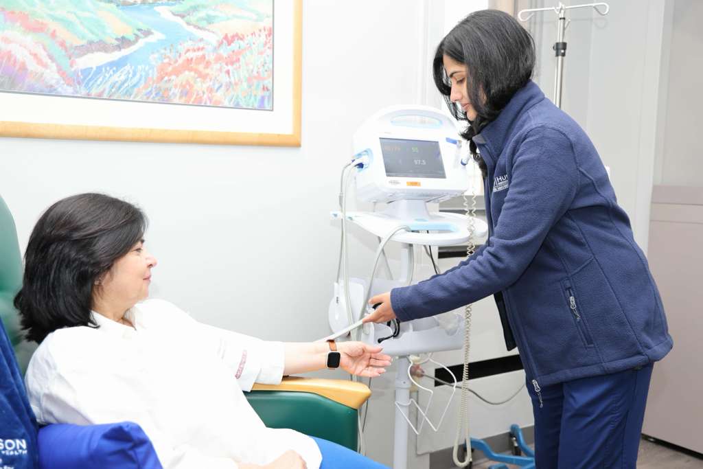 Nurse handing a patient documents during infusion treatment